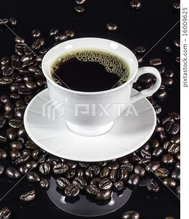 Coffee cup with roasted beans on black Coffee cup with roasted beans on black 16009625
