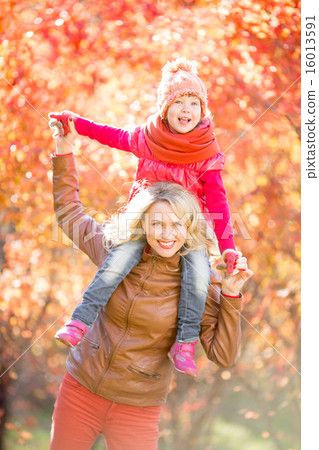 Happy family walking outdoor in fall Happy family walking outdoor in fall 16013591