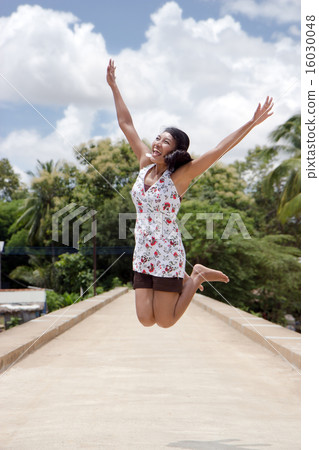 Girl jumping on the bridge 16030048