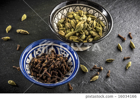 Two cups of spices, cardamom and cloves Two cups of spices, cardamom and cloves 16034166