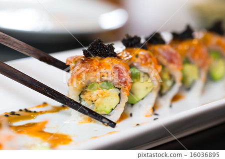 Sushi roll with black chopsticks 16036895