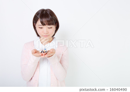 A nurse looking at a palm toy ambulance 16040490