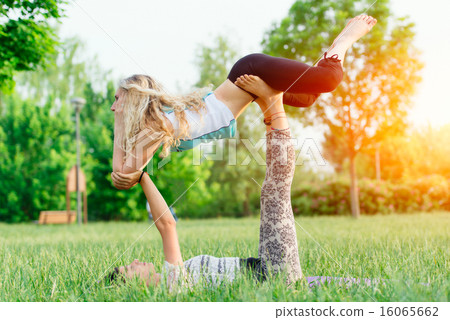 Couple practicing acroyoga in the park 16065662