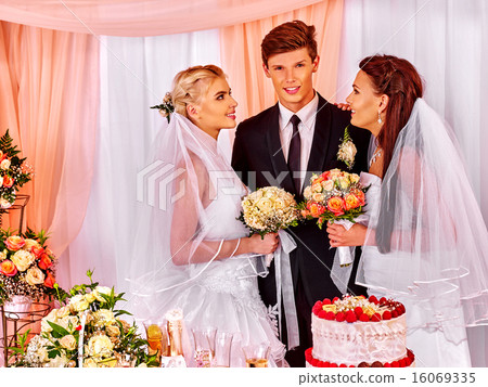 Happy wedding man and two bride. 16069335