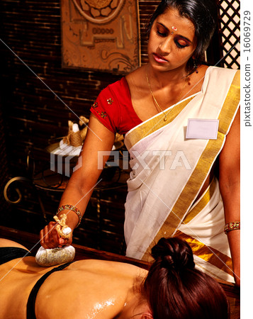 Woman having massage with pouch of rice. Woman having massage with pouch of rice. 16069729