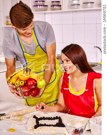 Young family cooking at kitchen. Young family cooking at kitchen. 16069781