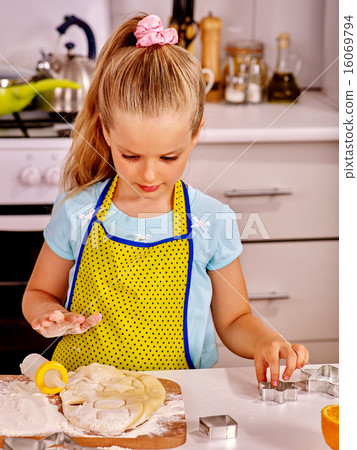 Child knead dough at kitchen. 16069794