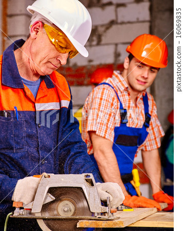 Group people  builder with circular saw . 16069835