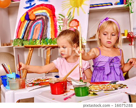 Child painting at easel. 16075288