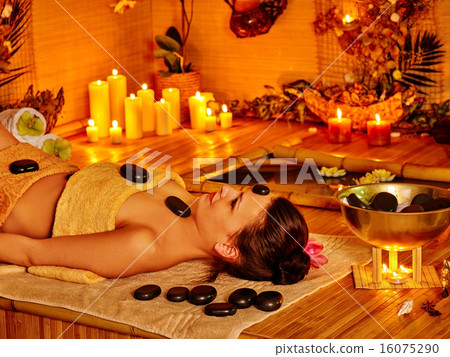 Woman getting stone therapy massage . 16075290