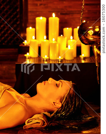 Woman having Ayurvedic spa treatment. 16075300