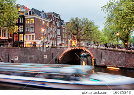 Canal Bridge and Boat Tour in Amsterdam at Evening 16085848