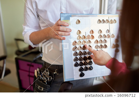 woman choosing hair color from palette at salon woman choosing hair color from palette at salon 16096712