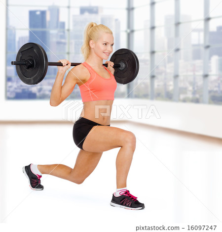 sporty woman exercising with barbell sporty woman exercising with barbell 16097247