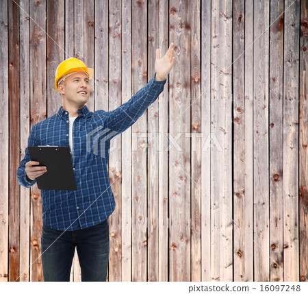smiling male builder in helmet with clipboard smiling male builder in helmet with clipboard 16097248