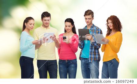 group of teenagers with smartphones and tablet pc group of teenagers with smartphones and tablet pc 16097249