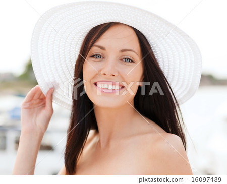 girl in hat standing on the beach girl in hat standing on the beach 16097489
