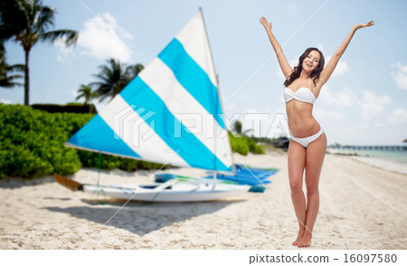 happy woman in bikini swimsuit dancing on beach 16097580