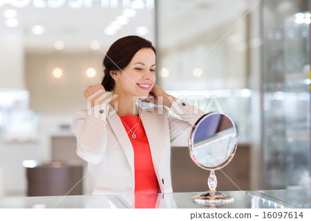 happy woman choosing pendant at jewelry store happy woman choosing pendant at jewelry store 16097614
