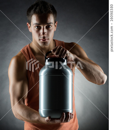 young male bodybuilder holding jar with protein 16098380