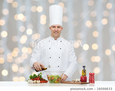 圖庫照片: happy male chef cook cooking food