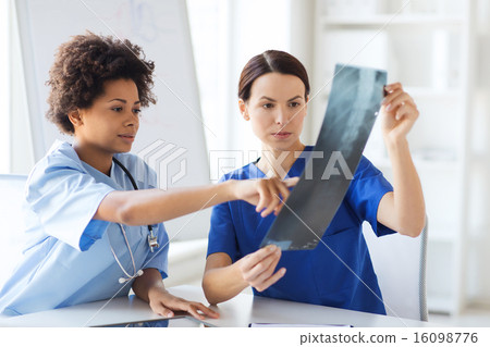 Stock Photo: female doctors with x-ray image at hospital