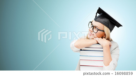 happy student in mortar board cap with books 16098859