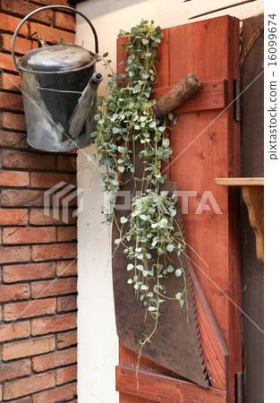 Old rusty watering can and saw 16099674
