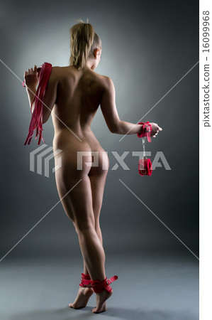 Rear view of naked submissive with BDSM attributes 16099968