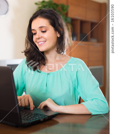 Young girl using laptop at home 16103590