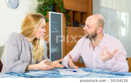 Couple with financial documents 16104236