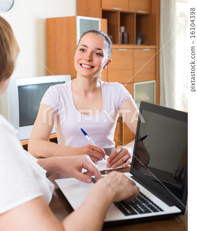 Woman and employee with laptop Woman and employee with laptop 16104398
