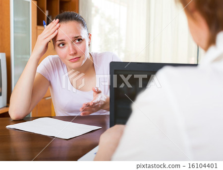 Sad woman filling questionnaire 16104401