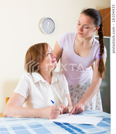 Serious sad female reading documents Serious sad female reading documents 16104435