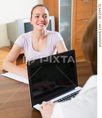 Woman and employee with laptop Woman and employee with laptop 16104470