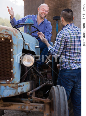 Farmers near agricultural machinery Farmers near agricultural machinery 16104609