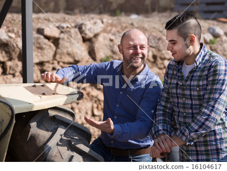 Farmers near agricultural machinery Farmers near agricultural machinery 16104617