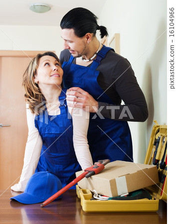Two playful workers flirting Two playful workers flirting 16104966