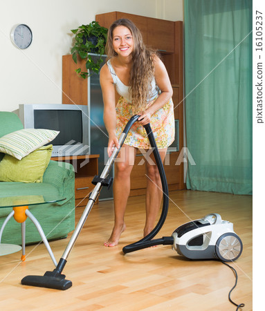 girl in skirt cleaning with vacuum cleaner 16105237