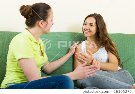Two casual women gossiping Two casual women gossiping 16105273
