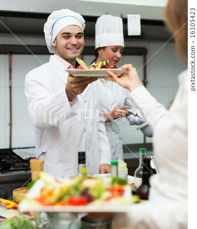 Waitress with food at kitchen 16105423