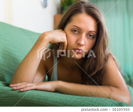Sad woman on sofa in home Sad woman on sofa in home 16105503