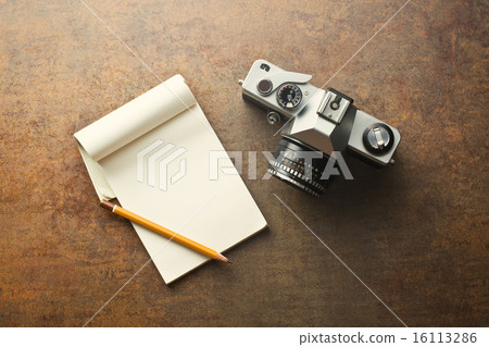 old analogue camera and notepad 16113286