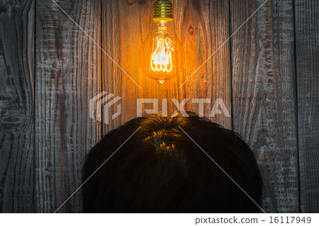 Head with Glowing bulb on the wood background 16117949