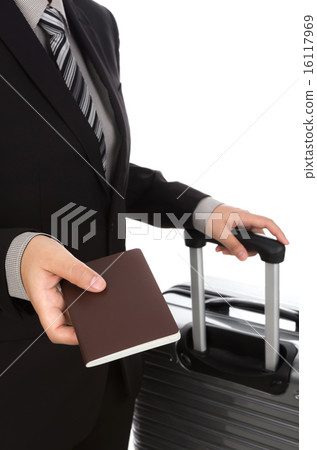 Business traveling pulling suitcase and holding passport Business traveling pulling suitcase and holding passport 16117969