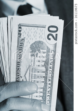 man in suit with dollar bills 16119673