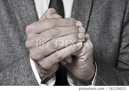 man in suit rubbing his hands 16120025