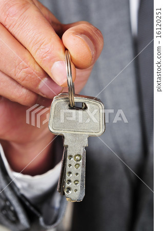 man in suit showing a key ring man in suit showing a key ring 16120251