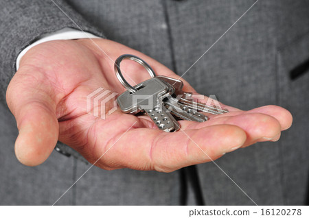 man in suit showing a key ring 16120278