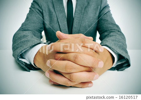 man in suit with clasped hands 16120517
